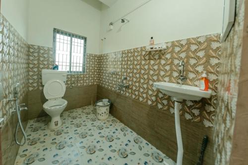 a bathroom with a toilet and a sink at White Lotus in North Lakhimpur