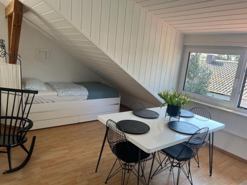 a room with a table and chairs and a bed at Bright and modern Apartment in Gröbenzell