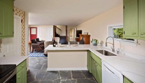 a kitchen with green cabinets and a kitchen sink at The Equinox Golf Resort & Spa in Manchester