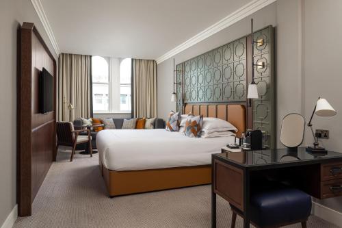 a hotel room with a bed and a desk at The Parkgate Hotel in Cardiff