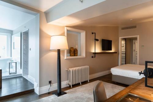 a bedroom with a bed and a lamp at The Bank Hotel Istanbul, a Member of Design Hotels in Istanbul
