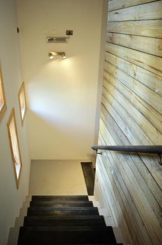 a stairwell with a wood accent wall at Apart Hotel Endurance in Punta Arenas