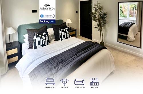a bedroom with a large bed with white and black pillows at Convenient City House By Ankers Contractors Accommodation Manchester With Free Parking in Manchester