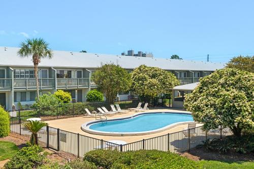 a swimming pool in front of a building at Beautiful coastal studio condo with pool in Santa Rosa Beach