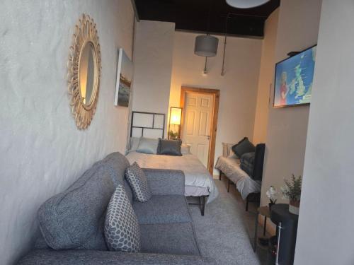 a living room with a bed and a couch at Downhill Beach Studio Suite in Coleraine