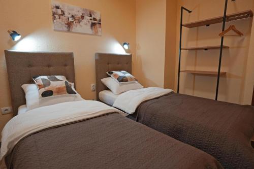 two beds in a room with at Apartmani u srcu grada in Zrenjanin
