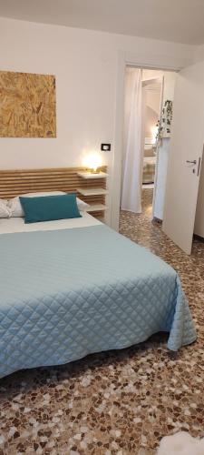 a bedroom with a large bed with a blue comforter at Casa dei sospiri in Polignano a Mare