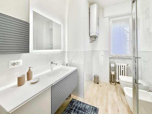 a white bathroom with a sink and a toilet at Milano Suite Francine in Milan