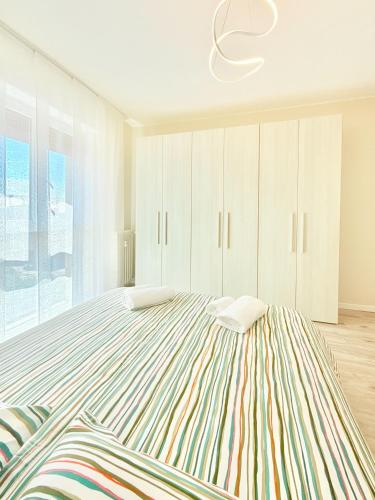 a bedroom with a large bed with white cabinets at Milano Suite Francine in Milan