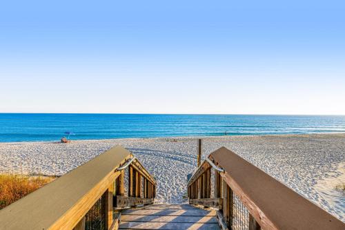 a stairway to the beach with the ocean in the background at Spacious Condo with Balcony in Navarre Beach with Shared Pool in Navarre