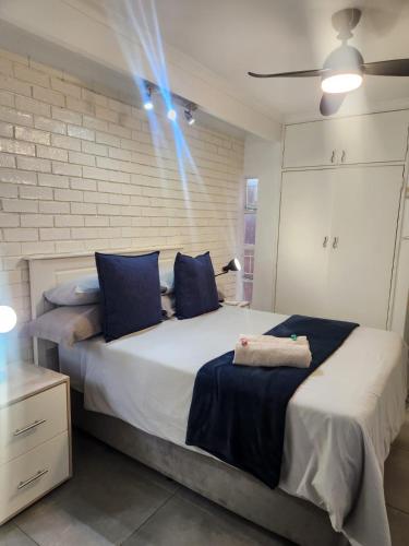 a bedroom with two beds with blue pillows at Ocean Sands Accommodation in Richards Bay