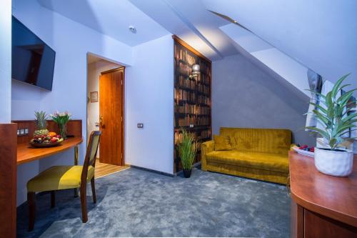 a living room with a couch and a table at Hotel Gottwald in Tata