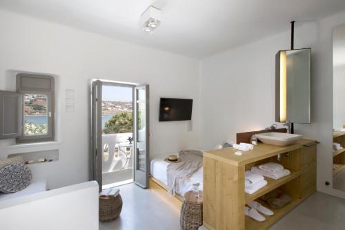 a white room with a bed and a mirror at The Dimora by Mazera in Ornos