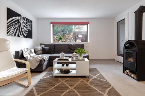 a living room with a couch and a fireplace at Hamburg - Haus - Airport 2 in Hamburg
