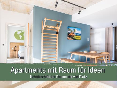 a room with a blue wall with a wooden ladder at 360 Grad by teamgeist Apartmenthaus - familienfreundlich - direkt am See mitten im Naturpark - Wassersportaktivitäten vor Ort in Kolberg