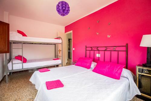 a bedroom with two beds and pink walls at MAS MIRONO in Fraga