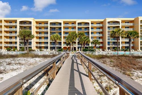 a walkway leading to a large building on the beach at First Floor Condo with a Partial Gulf View Splash Pad and More in Fort Walton Beach