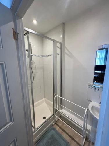 a bathroom with a shower and a sink at Brantwood Guest House in Christchurch