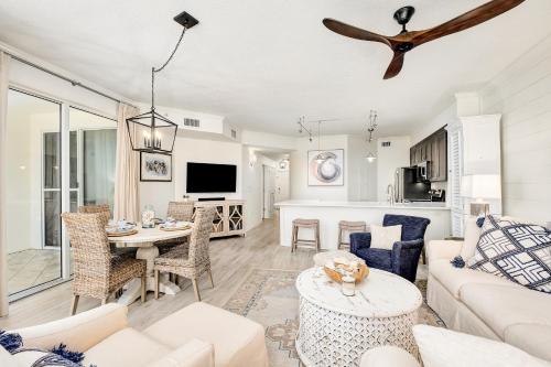 a living room with a couch and a table at Chic first-floor condo with Gulf & pool view & pickleball - steps to beach in Santa Rosa Beach