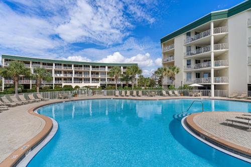 a swimming pool in front of a resort at Ground floor beachfront condo with shared pool and beach access in Santa Rosa Beach