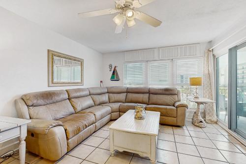 a living room with a couch and a table at Spacious home with balconies shared pool and beach access in Fort Walton Beach