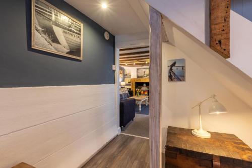 an attic hallway with a staircase with a wooden floor and a table at 3 Bed in Appledore oc-cockle in Appledore