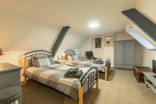 a bedroom with two beds in a attic at 3 Bed in Appledore oc-cockle in Appledore
