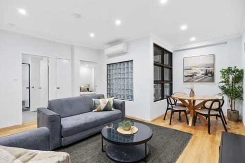 a living room with a couch and a table at River Fringe Urban Retreat in Perth