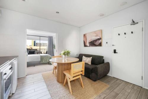 a living room with a couch and a table at Walk Everywhere - Large Apartment & Sofa Bed in Perth