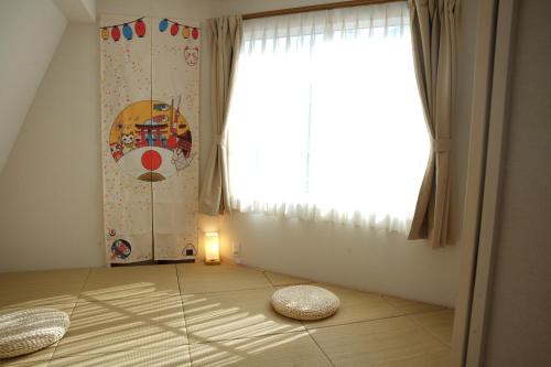 a room with a large window and a pillow on the floor at Limited Golden Week Deal , Ueno 10minutes, Tokyo University 10minutes, three BR, three toilets, Max 10 people Free parking in Tokyo