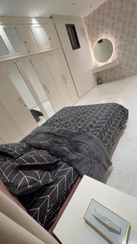 a large bed in a room with a table at ستارز هاوس in Najran