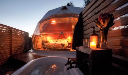 a bathroom with a bubble tent with a tub at Wilder Tasmania in Gowrie Park