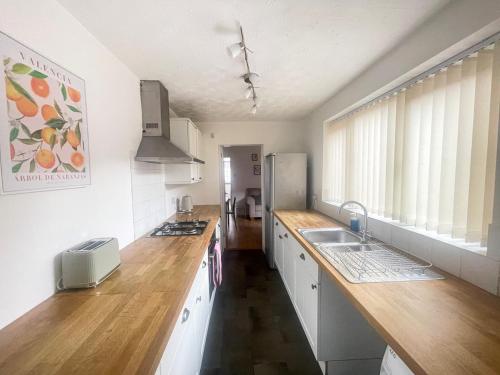 a kitchen with wooden counter tops and a refrigerator at 3 Bed plus Sofa sleeps 6 central in Middlesbrough