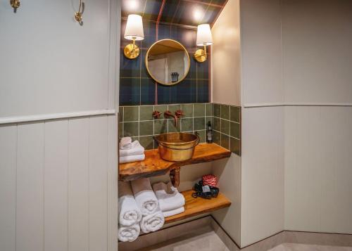 a bathroom with a sink and a mirror and towels at Wilder Tasmania in Gowrie Park