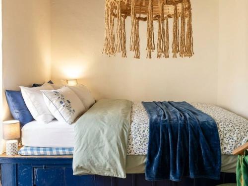 a bedroom with a bed with pillows on it at Heritage House Malonas in Malona Village