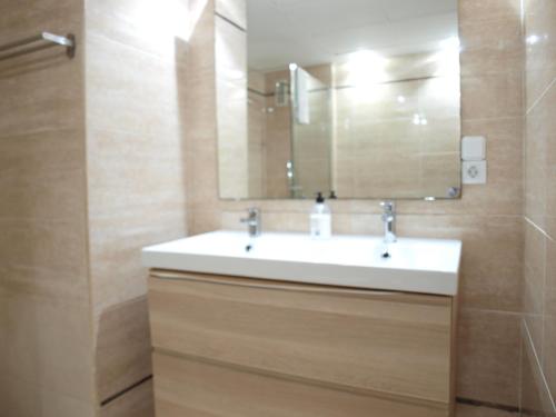 a bathroom with a white sink and a mirror at ApartUP Patacona Attic I in Valencia