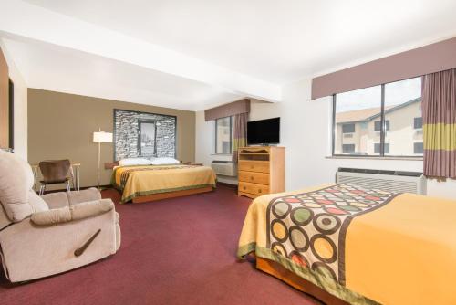 a hotel room with two beds and a tv at Super 8 by Wyndham Santa Rosa in Santa Rosa