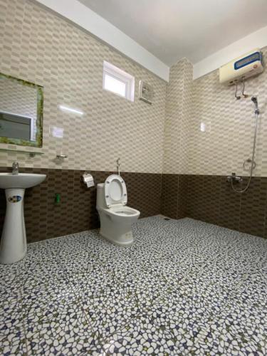 a bathroom with a toilet and a sink at Son Tinh Hotel in Phong Nha