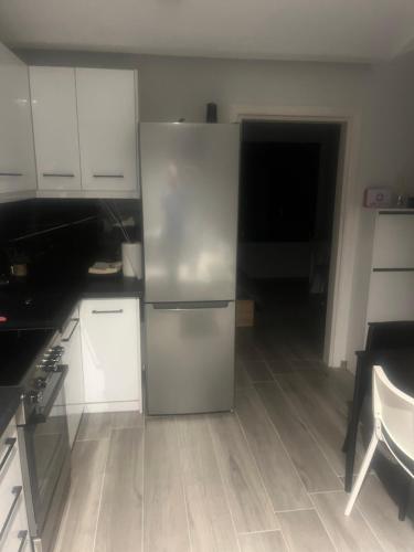 a kitchen with a stainless steel refrigerator in it at Zarko Home in Drama