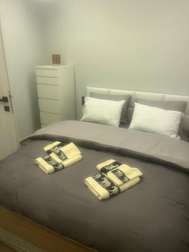 a bed with two towels on top of it at Zarko Home in Drama
