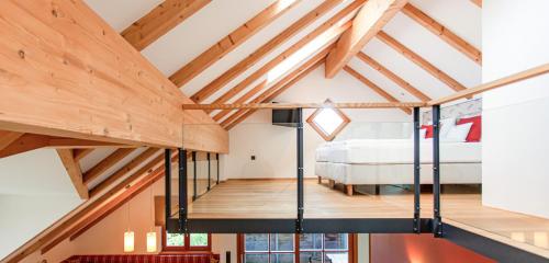 a bedroom in a loft with a bed at Dorfhaus Chalets in Oberstaufen