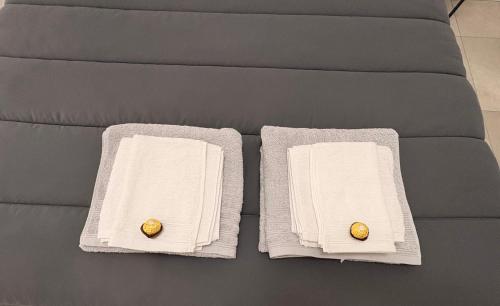 two towels with rings on them on a couch at Soul house in Corsico