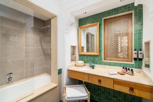 a bathroom with a sink and a shower and a tub at Jaal Riad Resort Adults Only in Marrakesh
