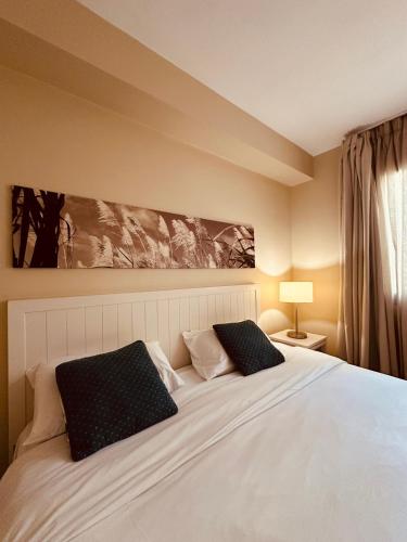 a bedroom with a large white bed with two pillows at Be Cosy Private Villa - Trou aux Biches in Triolet