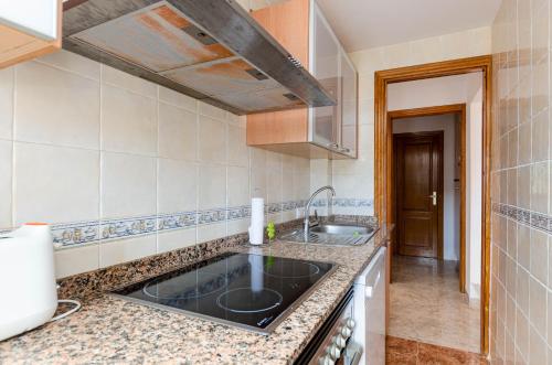 a kitchen with a sink and a counter top at YourHouse Sol i Mar 1 apartment in Cala Mesquida
