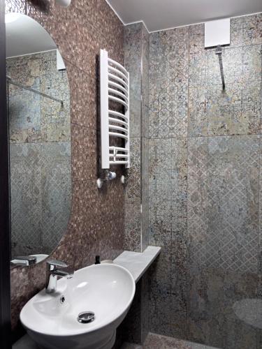 a bathroom with a sink and a mirror at Villa Morska Perła in Rewal