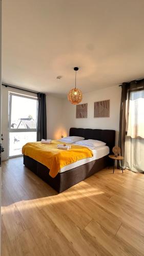 a bedroom with a large bed and a large window at AMAO-Sepia - Spacious Family Apartment - 6 Guests - Parking in Rheinhausen