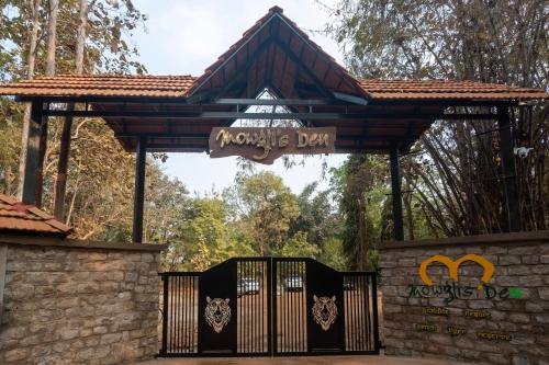 a gate at a monkey park with a sign that reads monkey day at Treebo Premium Mowgli's Den, Pench Tiger Reserve, Turia in Khawāsa