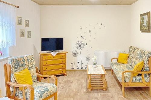 a living room with a couch and a tv at Gartenblick in Lübbenau