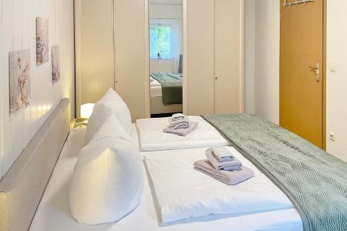 a bedroom with a bed with towels on it at Gartenblick in Lübbenau